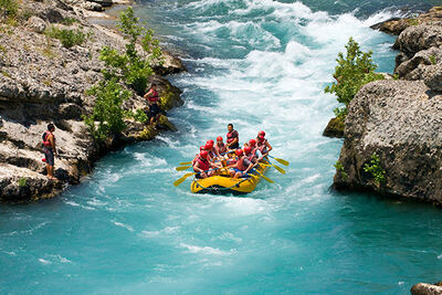 Raft running rapids through a narrow canyon