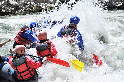 Rafters running a rocky, churning rapid